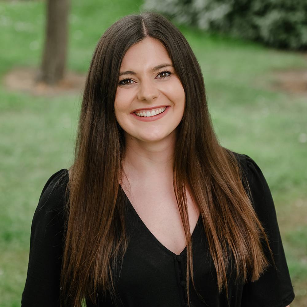 Woman smiling to camera outside