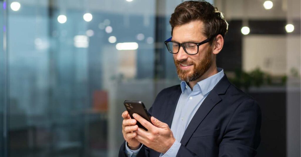 Man holding and using mobile phone