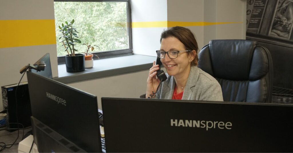 Woman on phone smiling in office