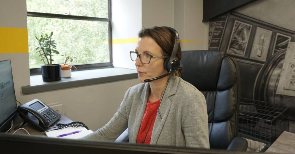 Woman working in office wearing headset