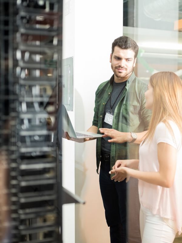 Man and woman talking in server room