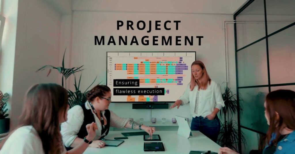 People working in meeting room with project management title over top