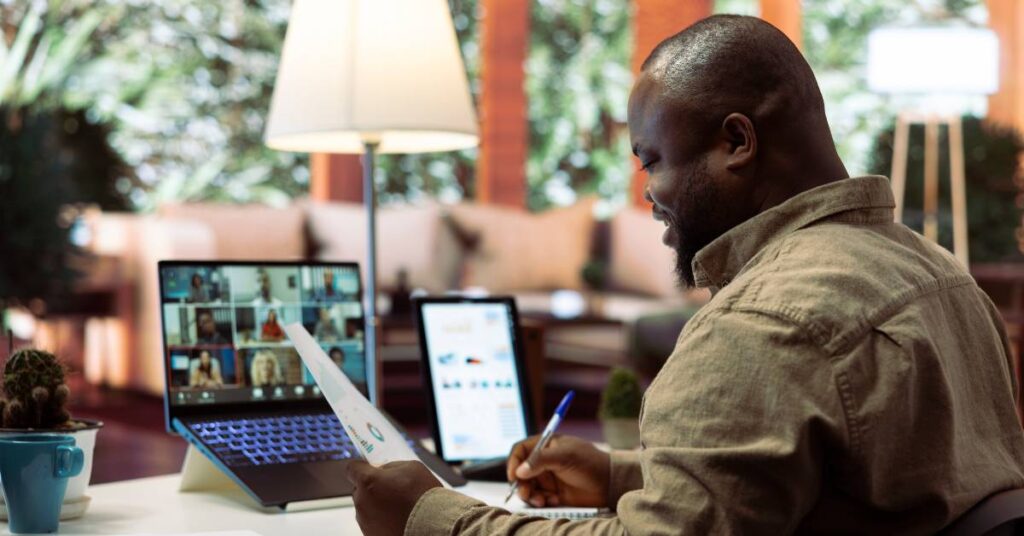 Man working on multiple devices at home on a desk