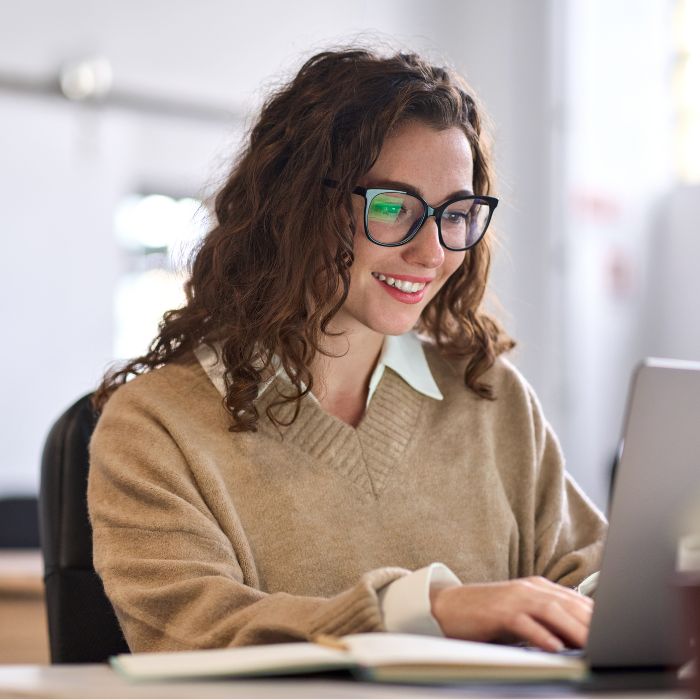 Woman on laptop smiling