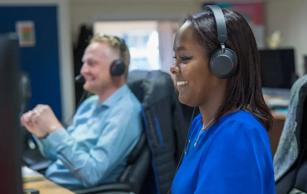 Two people with headsets on, talking on meetings