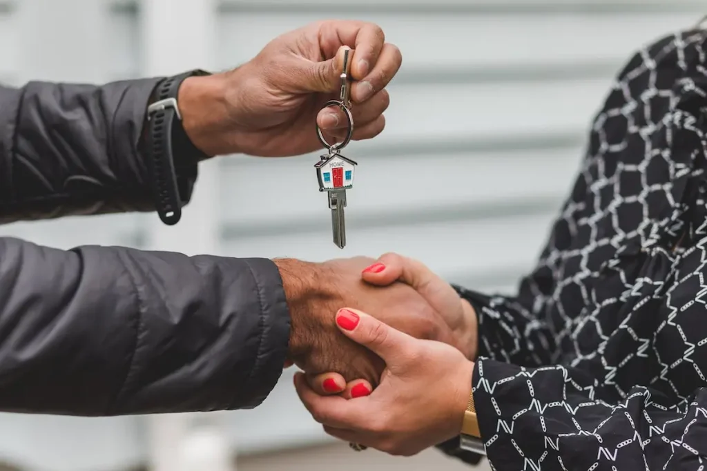 Realtor handing keys to client