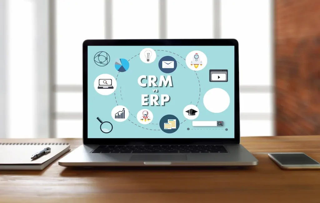 Laptop with 'CRM vs ERP' on the screen